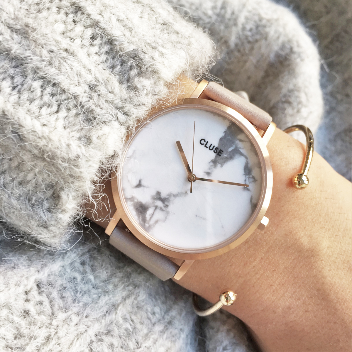 La roche in rose gold with white marble face.