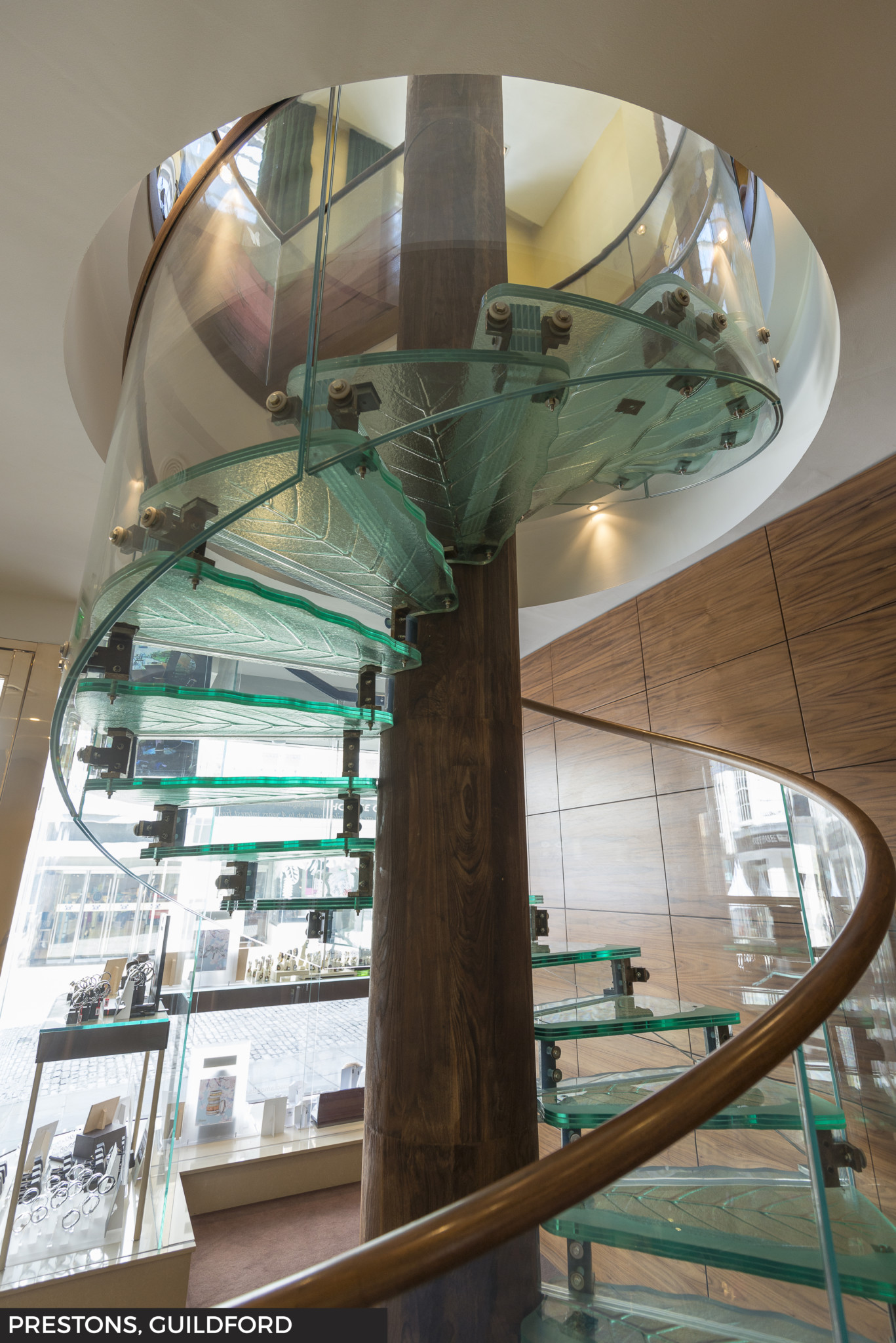 A striking spiral glass staircase connects the ground and first floors at prestons in guildford.