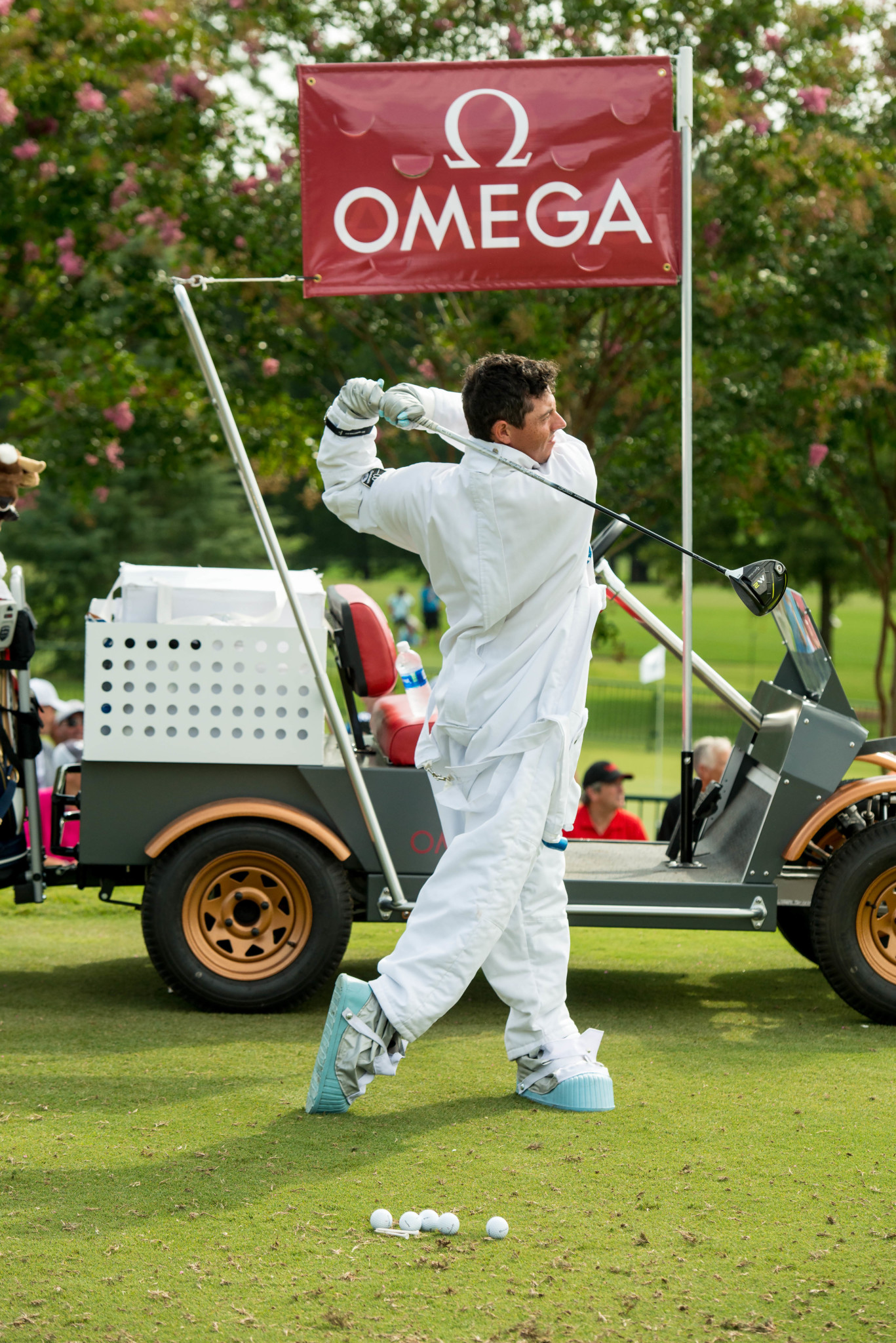 Rory mcilroy hits drive in astronaut uniform - omega
