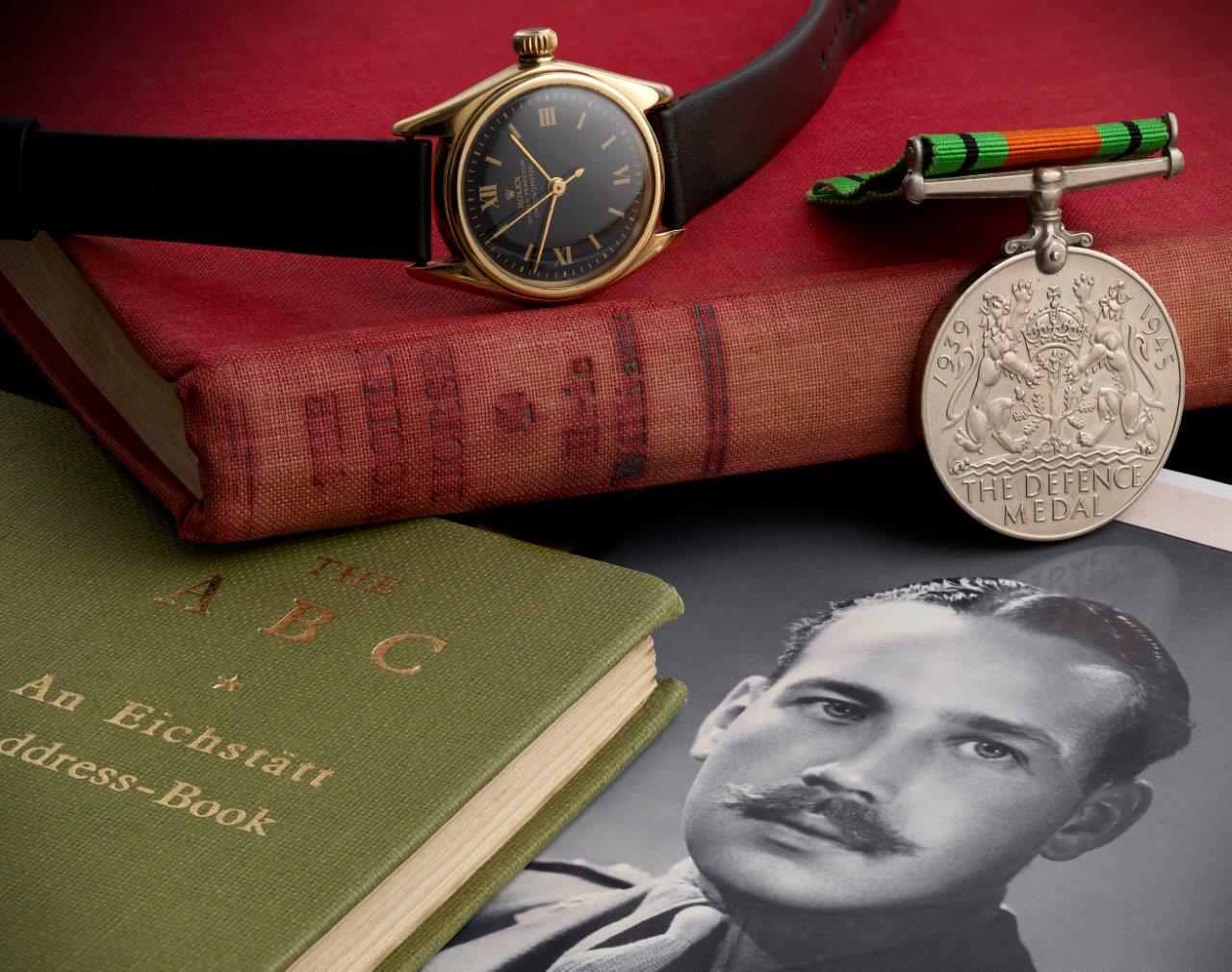 Picture of whitaker with rolex books and medals
